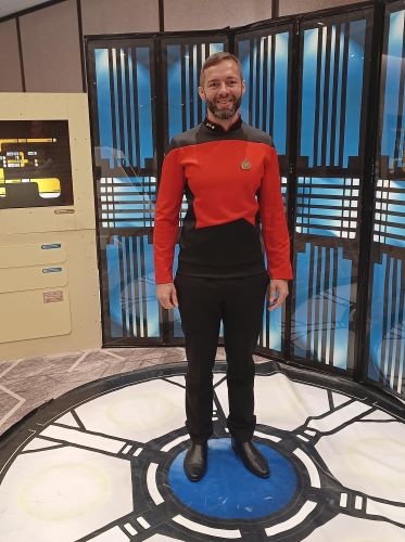 Rocky in starfleet uniform standing on a transporter